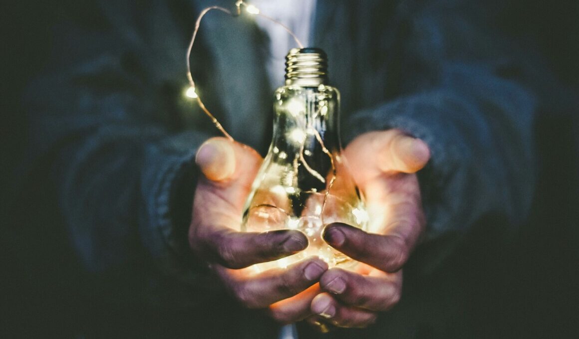 man holding incandescent bulb